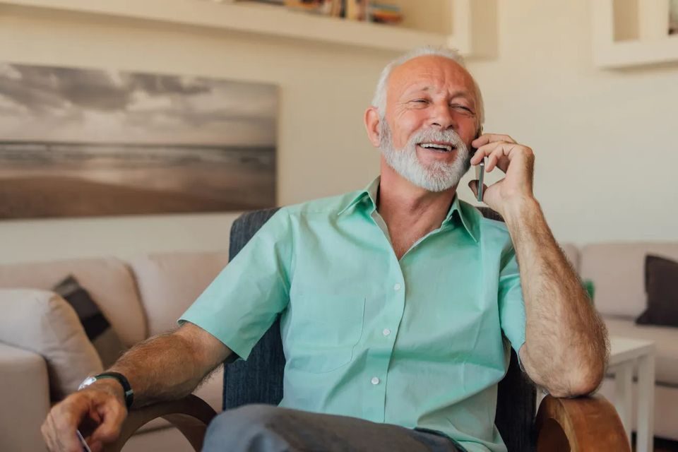 A Palm Springs homeowner relaxing at home while talking on the phone