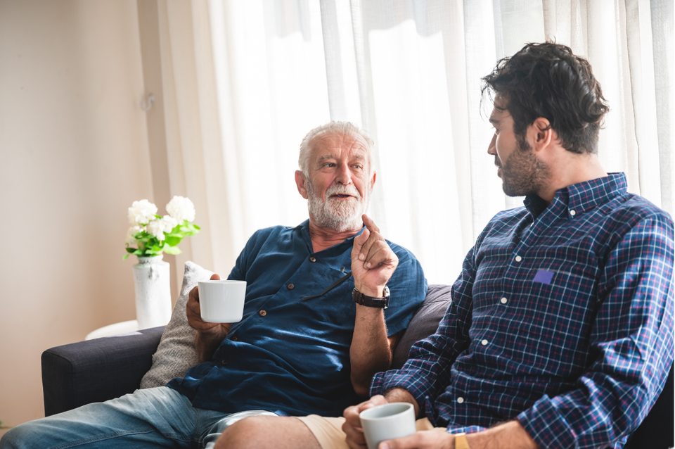 Philip talking with an older client in his living room