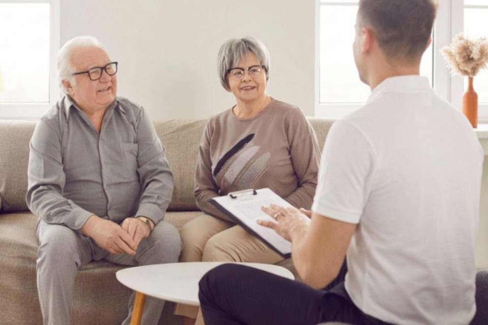 An older couple meeting with a Cliffrose partner at home