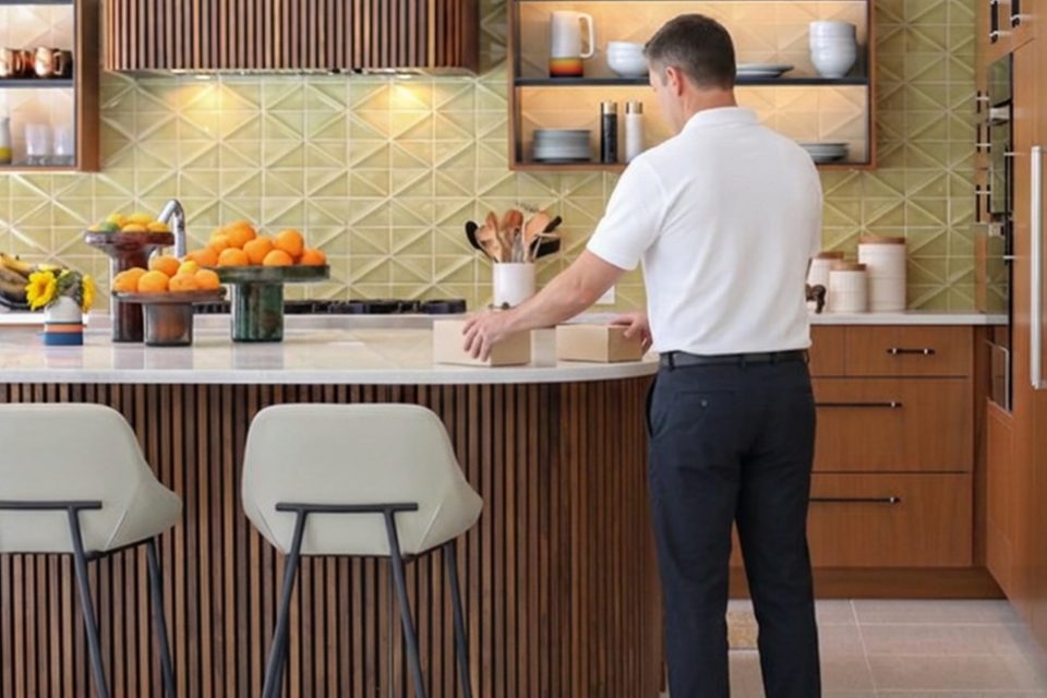 Nicholas checking a client kitchen during a home watch visit